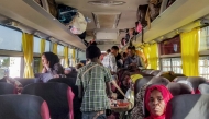 People displaced by conflict ride aboard a bus from Port Sudan in northeastern Sudan on January 7, 2025 to return home to the southern city of Singah in Sennar province, which was retaken by the Sudanese army forces from the Rapid Support Forces (RSF) in November 2024. (Photo by AFP)
