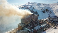 This handout photograph released by the Demiroren News Agency (DHA) on January 21, 2025, shows an aerial picture of a fire on the fourth floor of the 11-storey hotel in Bolu's Kartalkaya ski resort. (Photo by DHA (Demiroren News Agency) / AFP)

