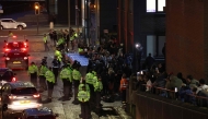 Police contain protesters as news spreads that Axel Rudakubana has left the court from a back entrance, outside The Queen Elizabeth II Law Courts in Liverpool, north west England on January 23, 2025, after the sentencing of the Southport attacker. (Photo by Darren Staples / AFP)
