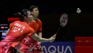 China's Guo Xinwa and Chen Fanghui hit a return against Japan's Hiroki Midorikawa and Natsu Saito in the mix doubles final match at the Daihatsu Indonesia Masters 2025 badminton tournament at Istora stadium in Jakarta on January 26, 2025. (Photo by BAY ISMOYO / AFP)