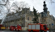 Firefighters vehicles are parked next to the townhall of the 12th district of Paris, on January 27, 2025, after it was hit by a spectacular fire. (Photo by Bertrand Guay / AFP)
 