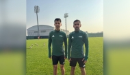 Qatar's International referees Abdulrahman Al Jassim (left) and Salman Falahi pose for a photo.