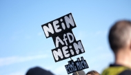 Participants display placards against the Alternative for Germany (AfD) party during a rally against the far right at the Theresienwiese in Munich, southern Germany, on February 8, 2025, almost two weeks ahead of parliamentary elections. (Photo by LUKAS BARTH-TUTTAS / AFP)
