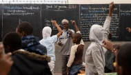 An English teacher points to a student after asking a question during English class at Alassane Ndiaye Allou Primary School in Dakar, on January 30, 2025. (Photo by PATRICK MEINHARDT / AFP)