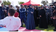 Minister of Education and Higher Education H E Lolwah bint Rashid Al Khater interacts with participants of NSD events at Old Doha Port Park yesterday.