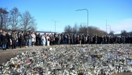 People gather at a makeshift memorial to observe a national minute's silence to honor the victims of the February 4 school shooting in Orebro, Sweden on February 11, 2025. (Photo by Jessica GOW / TT News Agency / AFP) / Sweden OUT
