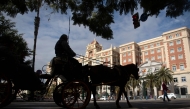 Tourists visit the town of Malaga in a horse-drawn carriage on February 10, 2025. (Photo by Jorge Guerrero / AFP)
 