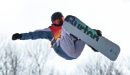 China's Wu Shaotong competes in the women's snowboard halfpipe qualification during the Harbin 2025 Asian Winter Games in Yabuli, Northeast China's Heilongjian province on February 12, 2025. (Photo by Hector RETAMAL / AFP)
