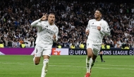 Real Madrid's French forward #09 Kylian Mbappe (C) celebrates scoring his third goal for a hat trick during the UEFA Champions League knockout phase play-off football match between Real Madrid CF and Manchester City at the Santiago Bernabeu stadium in Madrid on February 19, 2025. (Photo by OSCAR DEL POZO / AFP)
