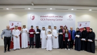 QCA President Mohammed Al Mudhahka poses with players and officials during the felicitation ceremony.