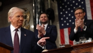US Vice President JD Vance and Speaker of the House Mike Johnson (R-LA) applaud as US President Donald Trump speaks during an address to a joint session of Congress in the House Chamber of the US Capitol in Washington, DC, on March 4, 2025. (Photo by Win McNamee / POOL / AFP)
