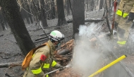 This photo taken on March 5, 2025 and released on March 6 by Japan's Fire and Disaster Management Agency shows firefighters battling a wildfire in Ofunato city of Iwate Prefecture. Photo by Handout / Fire and Disaster Management Agency / AFP