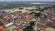 An aerial picture shows a flooded residential area after some rivers overflowed following heavy rain in Bekasi, a suburb of Jakarta, on March 5, 2025. (Photo by Aditya Irawan / AFP)
