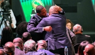 Former Cameroon star Samuel Eto'o (L) is greeted during the Confederation of African Football (CAF) general assembly and the election of a new executive committee, in Cairo, on March 12, 2025. (Photo by Khaled DESOUKI / AFP)