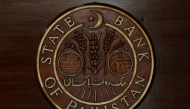 The logo of the State Bank of Pakistan (SBP) is pictured on a reception desk at the head office in Karachi, Pakistan July 16, 2019. REUTERS/Akhtar Soomro/File Photo

