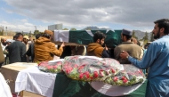 People carry the coffins of railwaymen killed by armed militants who ambushed a train in the remote mountainous area of Balochistan province, during their funeral in Quetta on March 13, 2025. (Photo by Banaras KHAN / AFP)
