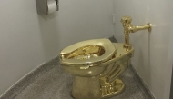 (FILES) A fully functioning solid gold toilet, made by Italian artist Maurizio Cattelan, is going into public use at the Guggenheim Museum in New York on September 15, 2016. (Photo by William EDWARDS / AFP)