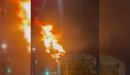 This frame grab taken from a UGC video shot and posted on X on March 21, 2025 by @fire_at_Vill shows a fire burning at a neighborhood electrical substation supplying power to Heathrow Airport in Hayes, west London. Photo by Handout / Courtesy of X user @fire_at_Vill / AFP