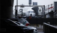A photograph taken on March 21, 2025 shows a plane parked on the tarmac at Heathrow airport following its closure after a fire broke out at a substation supplying power of the airport, in Hayes, west London. Photo by BENJAMIN CREMEL / AFP.
