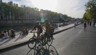 People along the Seine in Paris on September 3, 2023. (Photo by Toni L. Sandys/The Washington Post)
