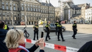 Police cordon the area as emergency services intervene where five person were wounded during a stabbing attack near the central Dam Square in Amsterdam on March 27, 2025. (Photo by Simon Lenskens / various sources / AFP) / Netherlands OUT
