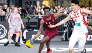 Qatar's Mohammed Hashem (left) dribbles during the game against China.