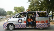 Rescue workers are seen in their vehicle after transporting the body of a victim to be buried at the Aye Yate Nyein Cemetery in Mandalay on March 31, 2025, three days after the deadly Myanmar earthquake. Photo by Sai Aung MAIN / AFP