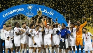 Al Bidda SC players and officials celebrate after winning the Second Division Cup trophy.