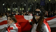 Georgian pro-Europe demonstrators stage an anti-government rally outside the parliament building in Tbilisi on March 31, 2025. Photo by Vano SHLAMOV / AFP.