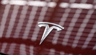 The Tesla logo is pictured on a car outside the US carmaker Tesla's German factory near Berlin, on November 20, 2024 in Gruenheide, eastern Germany. (Photo by Odd Andersen / AFP)

