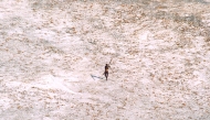 File photo of a Sentinel tribal man aims with his bow and arrow at an Indian Coast Guard helicopter as it flies over the island for a survey of the damage caused by the tsunami in India's Andaman and Nicobar archipelago, December 28, 2004. REUTERS

