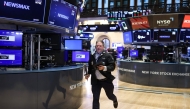 A trader runs on the floor of the New York Stock Exchange (NYSE) at the opening bell in New York City on April 3, 2025. (Photo by CHARLY TRIBALLEAU / AFP)
