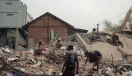 People sort through the rubble of a collapsed building in Mandalay on April 5, 2025, following the March 28 earthquake. Photo by Zaw Htun / AFP.