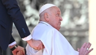 Pope Francis is pushed in his wheelchair after leading the Angelus prayer on St. Peter's square in The Vatican, on April 6, 2025. (Photo by Alberto PIZZOLI / AFP)