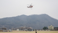 A firefighting KA-32A helicopter operated by Korea's Forest Aviation takes off in Yeongdeok on March 28, 2025, during operations to control wildfires. Photo by ANTHONY WALLACE / AFP
