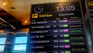 This picture taken on February 26, 2025 shows a flight information display at Madrid Barajas airport. (Photo by WAFAA ESSALHI / AFP)