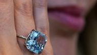 A Sotheby's employee displays the 10.03-carat 'Mediterranean Blue' diamond ring during a preview ahead of a public exhibition in Abu Dhabi on April 8, 2025. (Photo by Giuseppe Cacace / AFP)