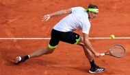 Germany's Alexander Zverev returns the ball to Italy's Matteo Berrettini during the Monte Carlo ATP Masters Series Tournament round of 32 tennis match on the Rainier III court at the Monte Carlo Country Club in Roquebrune-Cap-Martin on April 8, 2025. (Photo by Valery HACHE / AFP)