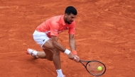 Serbia's Novak Djokovic plays a backhand return to Chile's Alejandro Tabilo during the Monte Carlo ATP Masters Series Tournament round of 32 tennis match on the Ranier III court at the Monte Carlo Country Club in Roquebrune-Cap-Martin on April 9, 2025. (Photo by Valery HACHE / AFP)