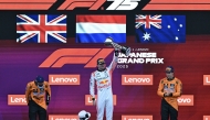 (L-R) Second-placed McLaren's British driver Lando Norris, winner Red Bull Racing's Dutch driver Max Verstappen, and third-placed McLaren's Australian driver Oscar Piastri celebrate on the podium after the Formula One Japanese Grand Prix at the Suzuka circuit in Suzuka, Mie prefecture, Japan on April 6, 2025. Photo by MOHD RASFAN / AFP.