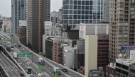 This general view shows an elevated expressway alongside highrise buildings in downtown Osaka on April 10, 2025. (Photo by Richard A. Brooks / AFP)
