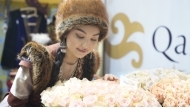 A woman views a bouquet at the International Exhibition of Floriculture and Green Industry in Astana, Kazakhstan, April 8, 2025. (Photo by Kalizhan Ospanov/Xinhua)