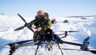 A Canadian soldier dismantles a drone as a team from the Canadian Navy test thermal imaging drone capabilities in Arctic environments, during Operation Nanook, the Canadian Armed Forces' annual Arctic training and sovereignty operation, in Inuvik, Northwest Territories, Canada, February 27, 2025. (Photo by Cole Burston / AFP)
 