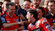 Pole position winner, Ducati Lenovo's Spanish rider Marc Marquez, celebrates with his team following the qualifying session for the Qatar Moto GP Grand Prix at the Lusail International Circuit on April 12, 2025. (Photo by Karim JAAFAR / AFP)
