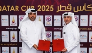 Executive Director of Sales, Marketing and Communication at QSL Hassan Rabiah Al Kuwari (right) and Founder and CEO of We Make Events Hamza Taleb Al Sairi pose for a picture after signing the sponsorship agreement. 