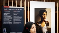 World Press Photo of 2025 award winner Samar Abu Elouf poses next to her winning photograph depicting a nine-year-old Palestinian boy who lost both arms during an Israeli attack on Gaza City at the Nieuwe Kerk in Amsterdam on April 17, 2025. (Photo by Robin van Lonkhuijsen / ANP / AFP) 