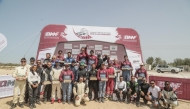 The podium winners pose for a group picture after the  second round of the Qatar Off-Road Championship. 