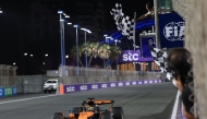McLaren's Australian driver Oscar Piastri crosses the finish line to win the 2025 Saudi Arabia Formula One Grand Prix at the Jeddah Corniche Circuit on April 20, 2025. (Photo by Thaier Al Sudani / POOL / AFP)