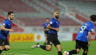 Mohamed Abdula Methnani (centre) celebrates after scoring the winner for Al Sailiya against Muaither.  