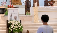 A portrait of Pope Francis is seen displayed at the altar of St. Francis Xavier Catholic Church in Kuta on Indonesia's resort island of Bali on April 22, 2025, a day after his death. Photo by SONNY TUMBELAKA / AFP.